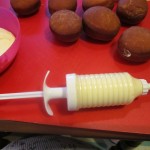 Handy decorating syringe used for filling the doughnuts
