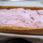 Spread softened ice cream over cake and re-roll.