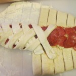 Cut strips of dough and fold over the filling